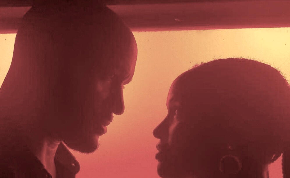 the heads of a couple lit by a setting sun